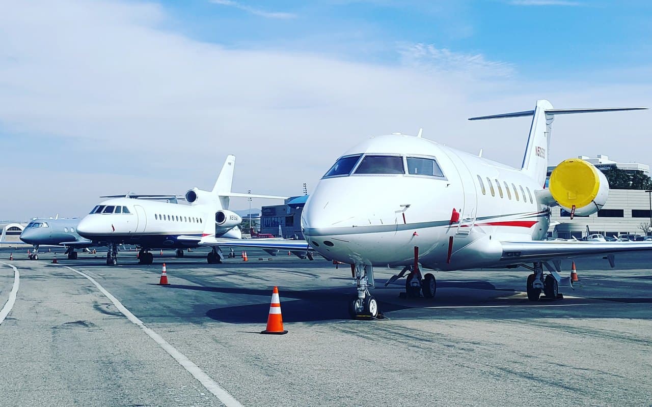 Business jets parked on a private-terminal ramp