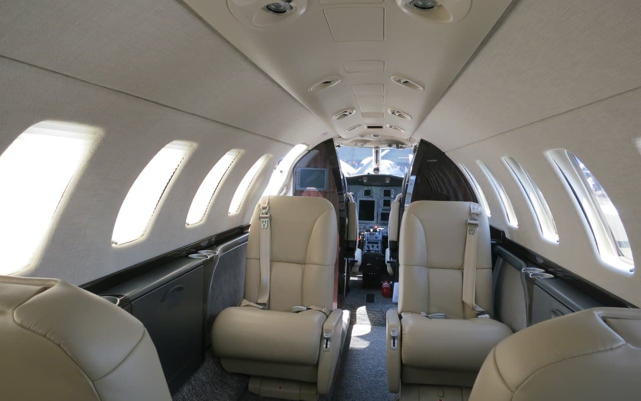 Inside a private jet cabin, looking forward to the cockpit